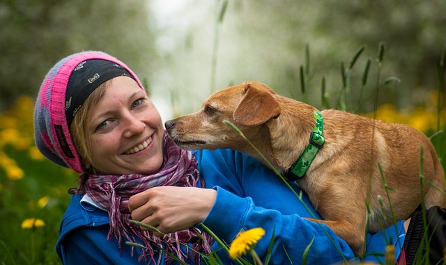 A woman with a wide smile and her dog. Image by Susanne from Pixabay.&nbsp;